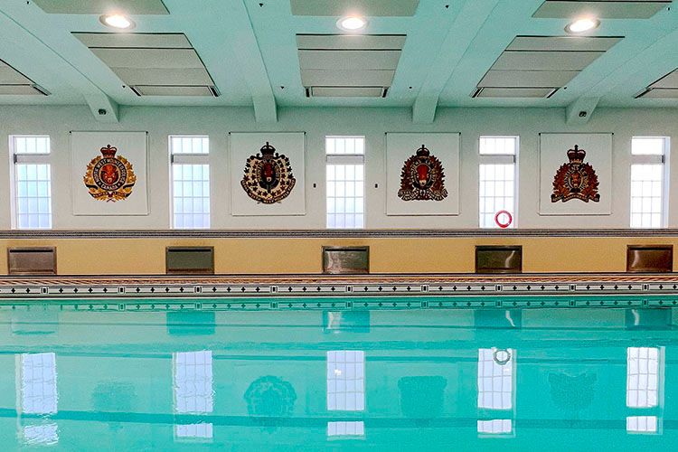 The Depot Pool with four large posters of historic badges on the wall.