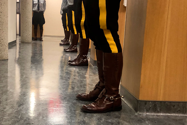 Cadets stand outside their pits for inspection. They are wearing boots and breeches.