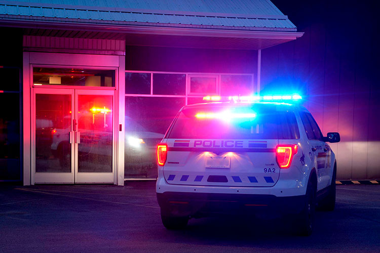 A police vehicle with red and blue lights flashing.