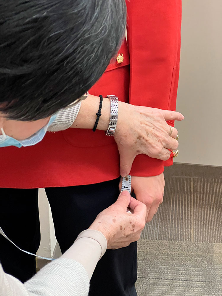 A tailor uses a measuring tape.