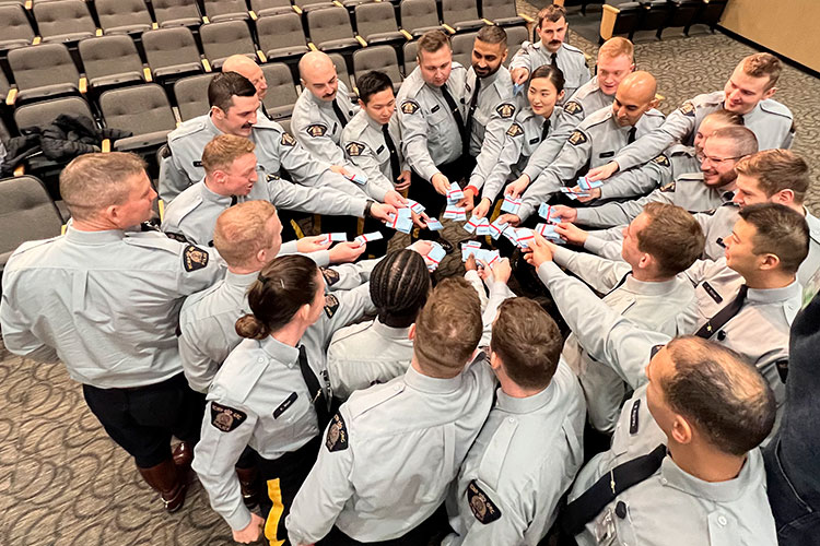 A group of cadets get ready to throw epaulettes in the air.