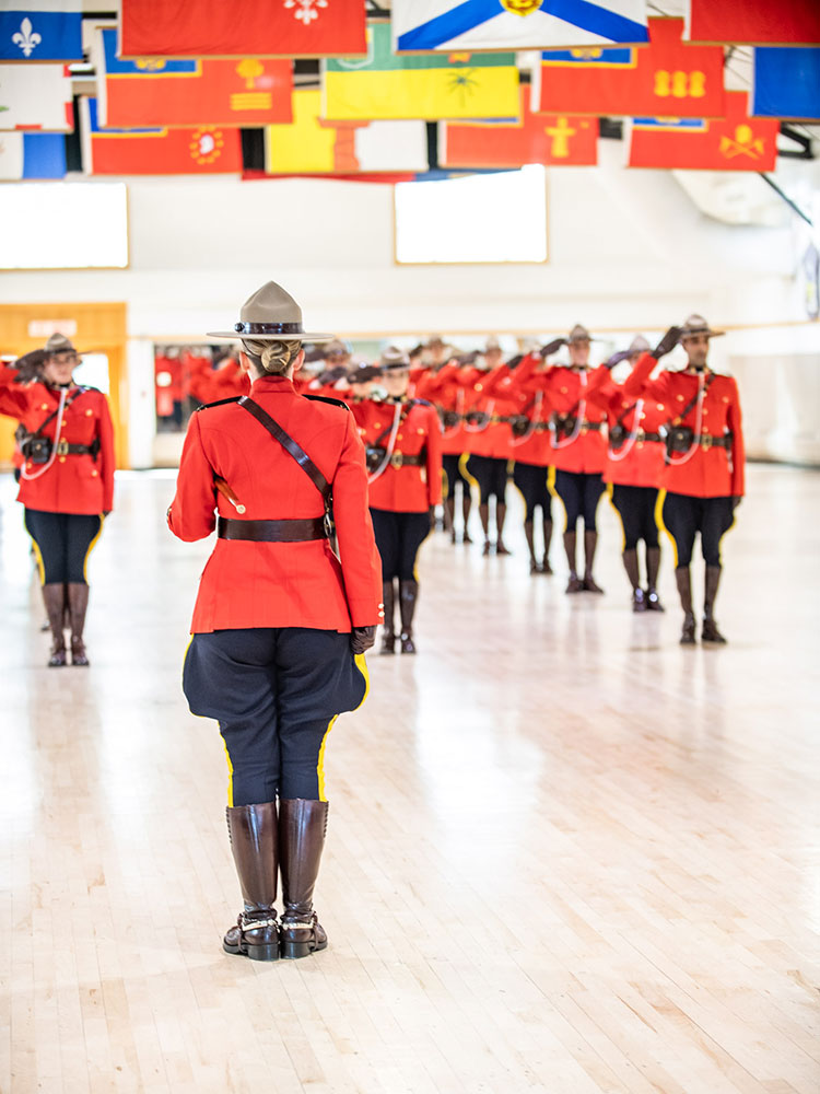 New constables in red serge can be seen saluting.