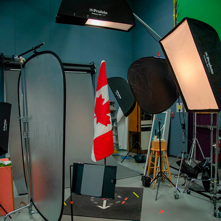 Behind the scenes in the photography studio with lights, reflectors and the Canadian flag