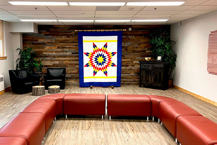 A blue Starblanket on display in a room with open seating.