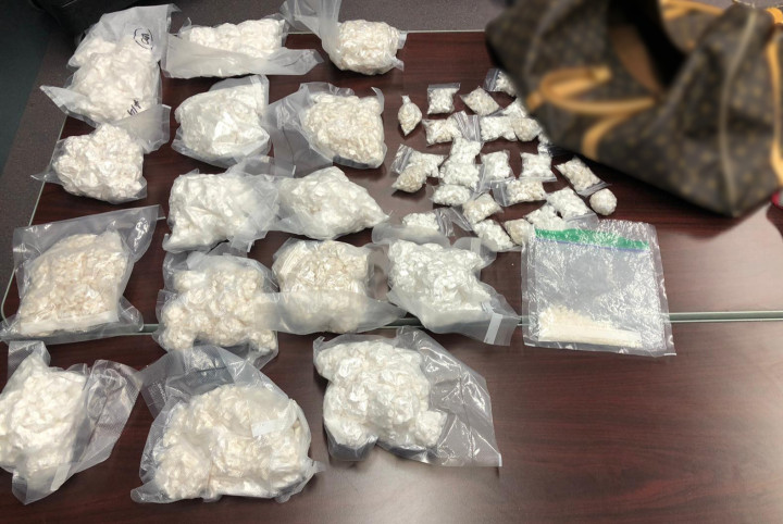 A search of the residence resulted in the seizure of several items, some of which include, approximately 9.8 lbs of prepackaged cocaine in vacuum sealed bags, approximately 350 grams of marijuana, a firearm with two loaded magazines and over $25000 in cash.