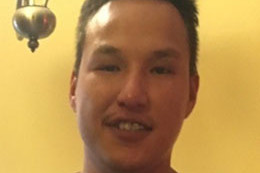Shack is described as approximately 6' tall and 215 lbs. He has brown eyes and brown hair. He has a scar on his left cheek and his top front tooth is missing. 