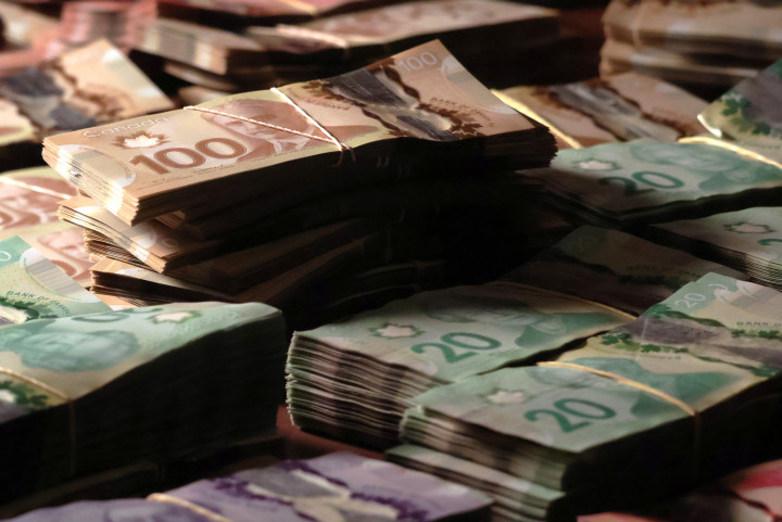  Photo of large quantities of proceeds seized in Canadian currency bound and placed on a table. 