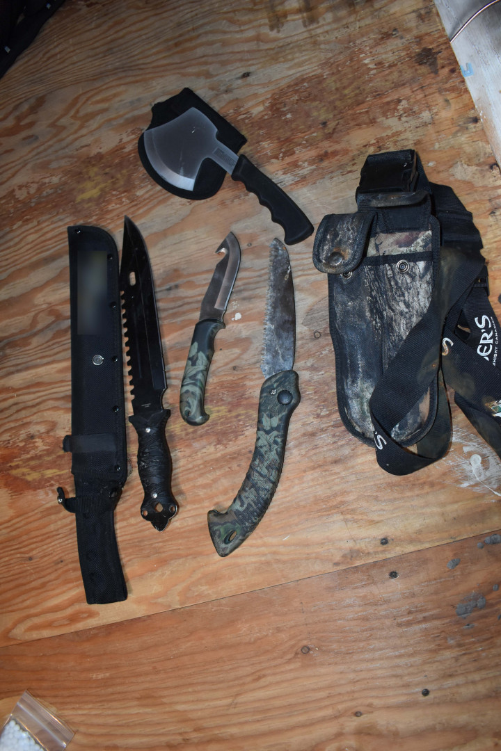 A search of the property incidental to the arrest resulted in officers locating and seizing a handgun with the serial number defaced, approximately 4 oz. of suspected cocaine, a sum of cash in both Canadian and US currency, a cross-bow, drug paraphernalia, knives, a machete and a hatchet. 