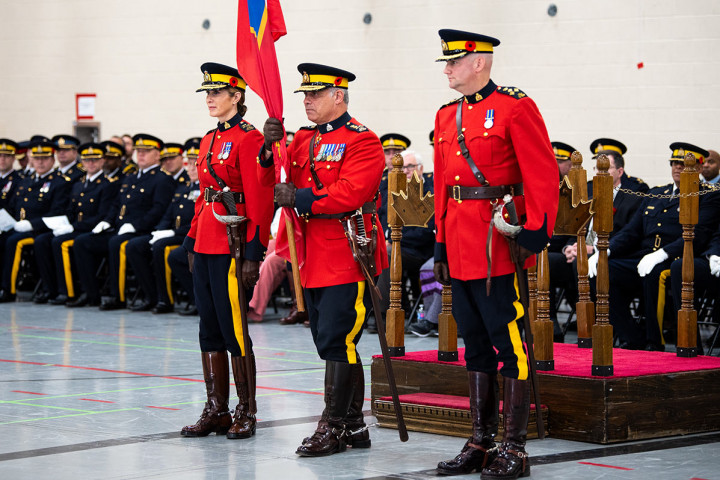 Former Commanding Officer, Deputy Commissioner Jodie Boudreau, and new Commanding Officer, Assistant Commissioner Matt Peggs, with RCMP Commissioner Mike Duheme who is holding the O Division ensign