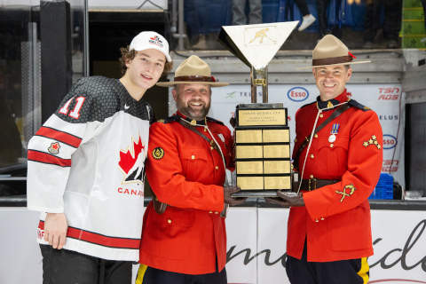 (Left to right) Team Canada White defenceman Matthew Schaefer, Constable Lorenz Sanders and Staff Sergeant Michael Robinson with the World Under-17 Hockey Challenge trophy