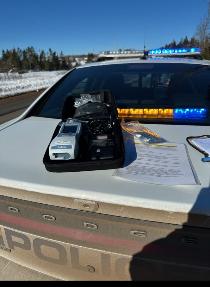 A breath test kit on the trunk of an RCMP patrol car