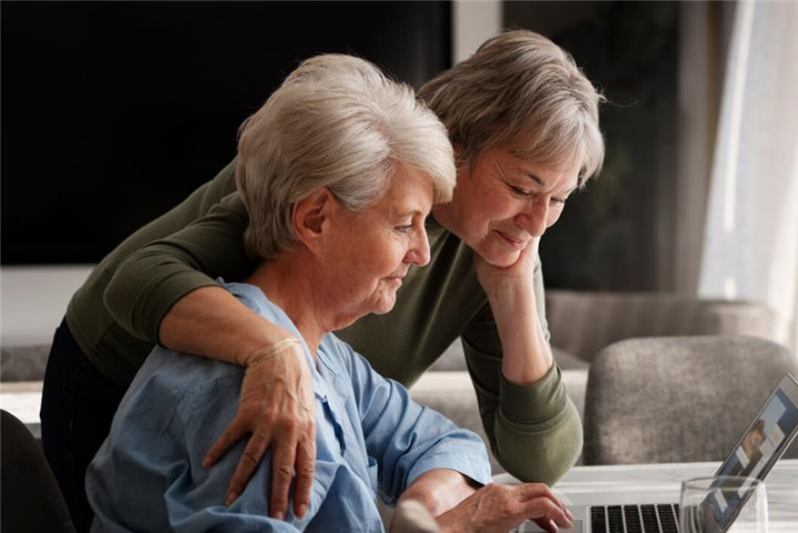 Two women at a laptop