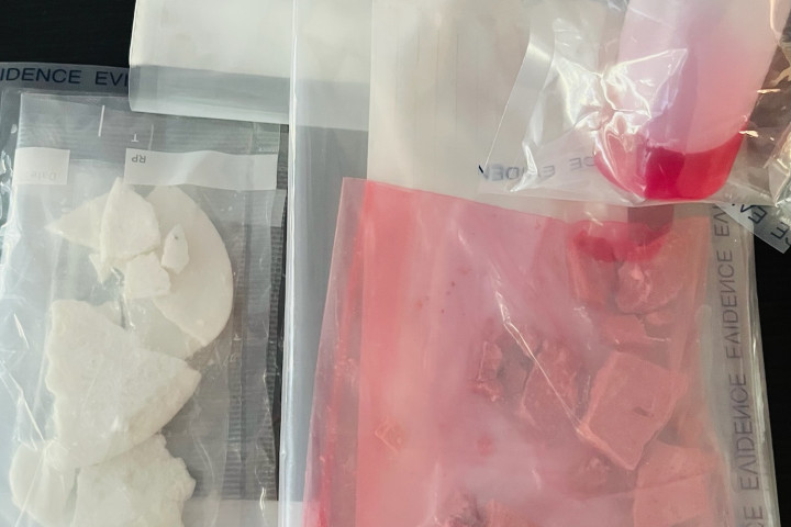 A photo of various drugs in bags and other paraphernalia. 