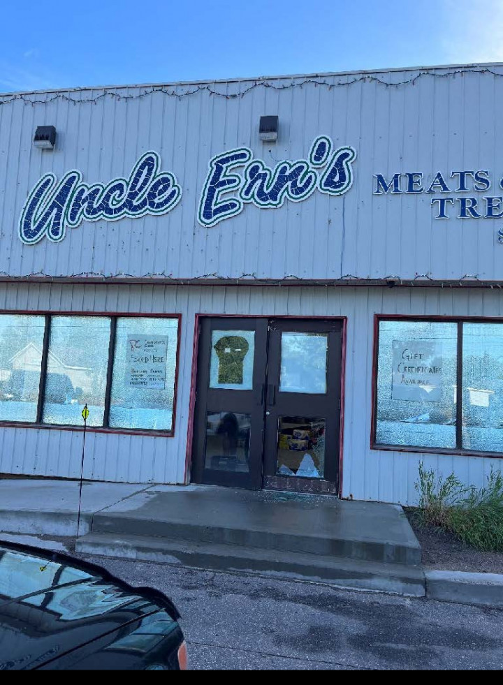 A picture of Ern's Meats and Treats shows damage to the front door.