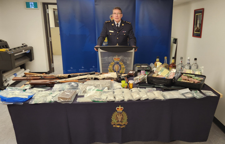 A uniformed police officer stands behind a podium.