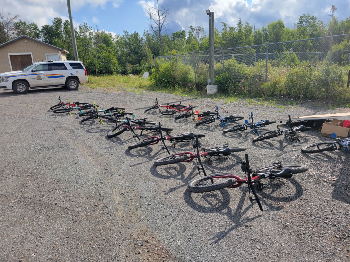 An RCMP patrol SUV parked in the background of a number of pedal bicycles being prepared for the Hop On PEI bike safety rodeo