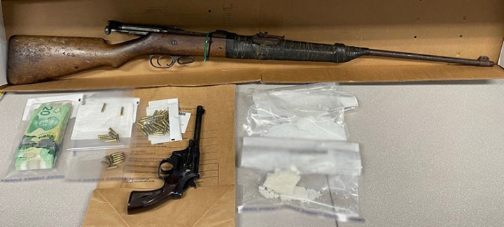 a loaded handgun, a rifle, approximately 81 grams of methamphetamine, approximately 58 grams of crack cocaine, ammunition, a sum of cash and drug trafficking paraphernalia. 