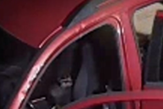 Damage to paint on a vehicle is seen around the frame of the front driver side door.